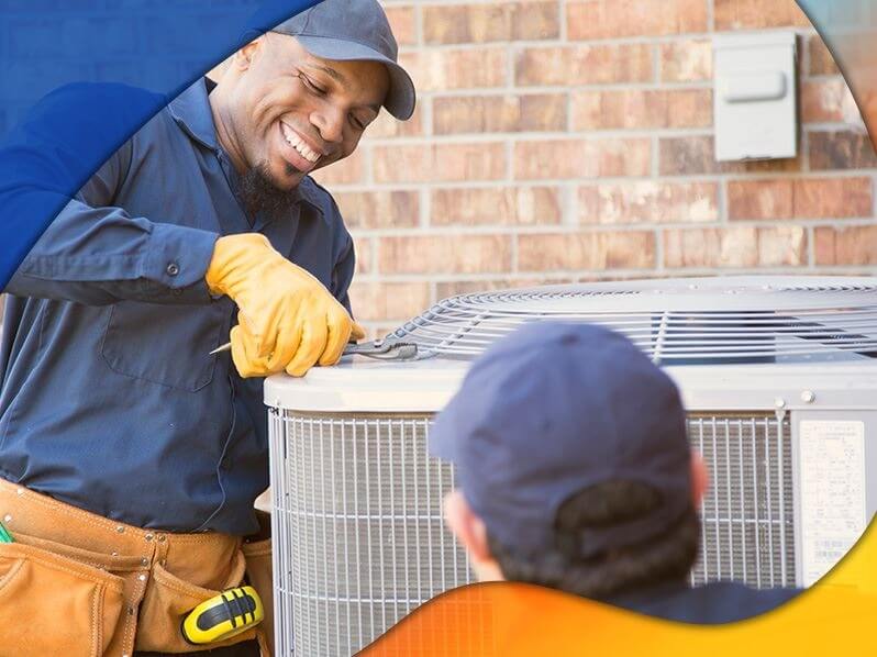 Two techs working on AC unit