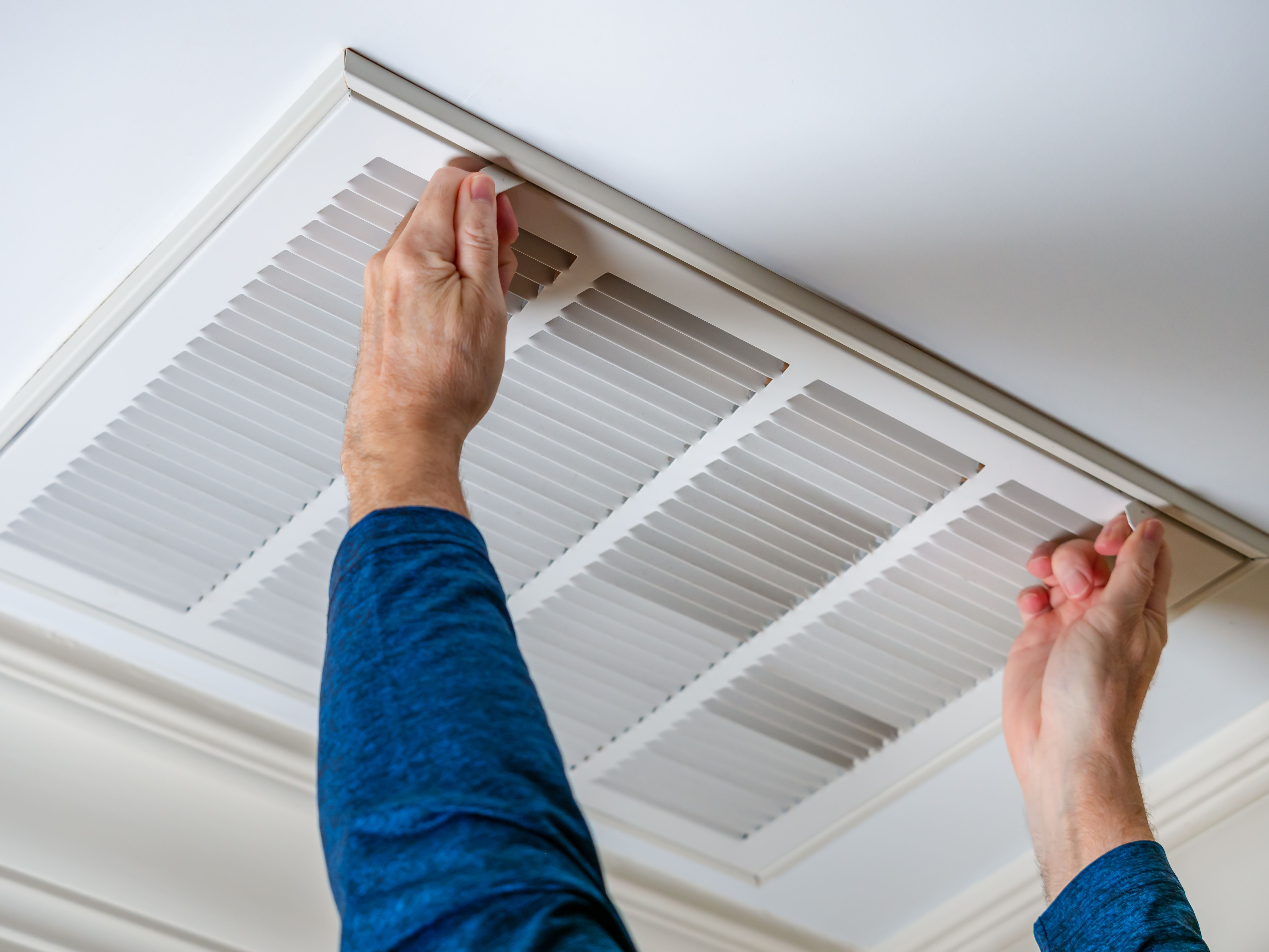 man opening air vent